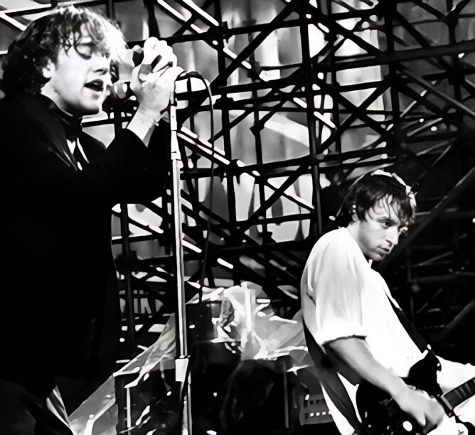 R.E.M.'s Michael Stipe (left) & Peter Buck perform at NYC's Shea Stadium, August 1983