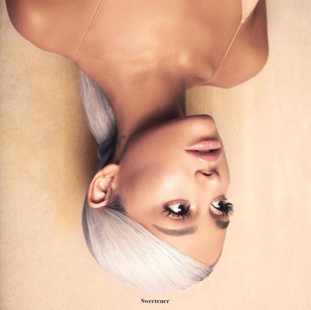 Everything We Know About Ariana Grande's New Album <i></noscript>Sweetener</i>” title=”ariana-grande-sweetener-album-1529442755″ data-original-id=”294597″ data-adjusted-id=”294597″ class=”sm_size_full_width sm_alignment_center ” data-image-source=”getty” />
<p>The new album cover is a departure for Grande, whose previous covers were all shot in black and white. <em>Sweetener</em> is brightly lit, albeit upside down, and Grande has continued the theme by teasing track names and other hints in flipped text that renders her album title as “ɹǝuǝʇǝǝʍs.” The topsy-turvy aesthetic also features heavily into the “No Tears Left to Cry” video. In a <a href=