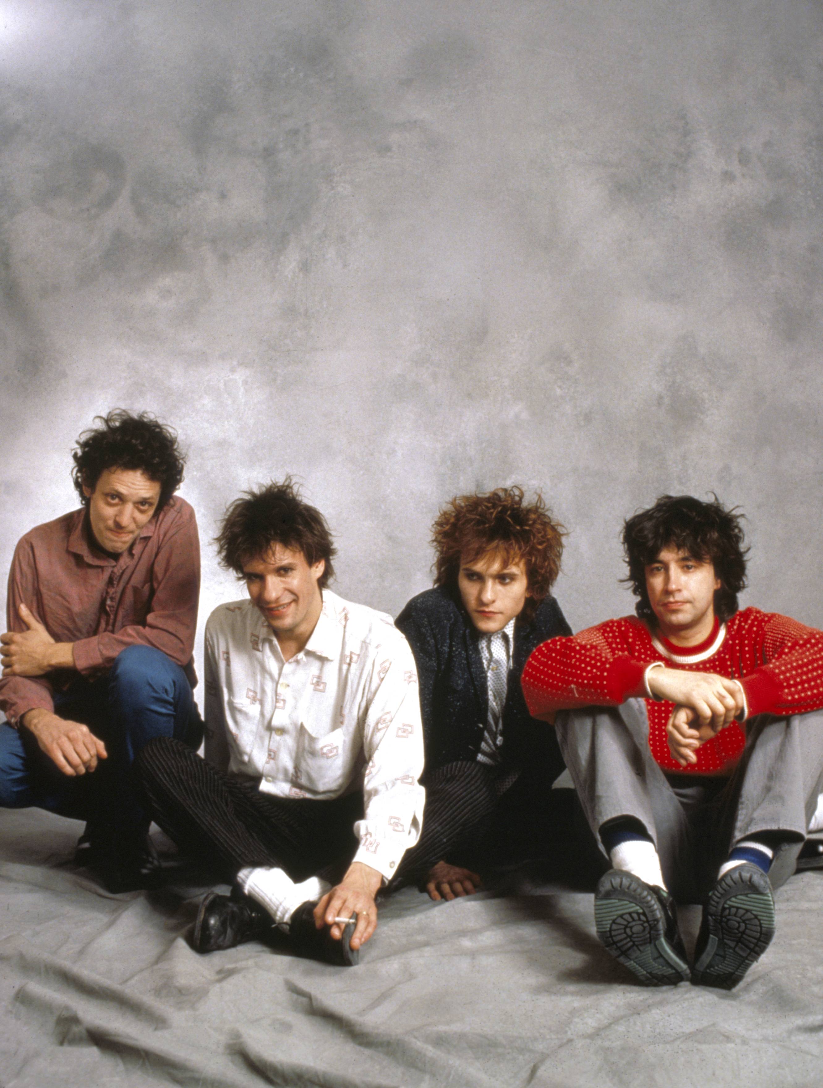 The Replacements: Our 1987 Feature, <i></noscript>
<p>Jesperson likewise had been with the group since the beginning. In 1980, less than a month after their first gig, he signed them to Twin/Tone Records, which he had cofounded, and immediately became their manager. But when they jumped to Warner Brothers in 1985, they moved beyond his managerial depth. Jesperson and the band went their separate ways last August, a move Westerberg feels was, in many ways, harder to digest than the decision fire Stinson.</p>
<p>“Peter was like a fifth member of the band, and in the beginning, I’d give him a lot of credit for our success. He was invaluable. When we had no money at all, he would always buy us drinks and lunch and things like that. He kept us together in the beginning. And then we grew up a little. We were young when we started—I was 19, Tommy was 13, and he was six or seven years older, and he could calm us down when we needed it. Consequently, we grew up to the point where we could call ’em ourselves. We didn’t need a ‘dad’ or a ‘big brother’ anymore; we needed someone to guid our career more than we needed someone to take care of us.”</p>
<p>Warner Brothers provided the career-guiding management to replace Jesperson. To fill the void Stinson left, the band chose Bob “Slim” Dunlap, longtime sidekick of local legend Curtiss A. His “audition” consisted of an afternoon of drinking beer.</p>
<p>“Slim is more like a fourth member of the band than a hired gun,” Westerberg says. “We originally thought that it would be a good idea to get a hot guitar player and be the Replacements and…Joe Blow. As it is now, it’s like the Replacements with a new guy who isn’t a <i>great</i> guitar player, isn’t a <i>great</i> singer, just as we are not great at what we do, and he fits in perfectly. He’s working out good, but the tale will really be told when we play live.”</p>
<div class=