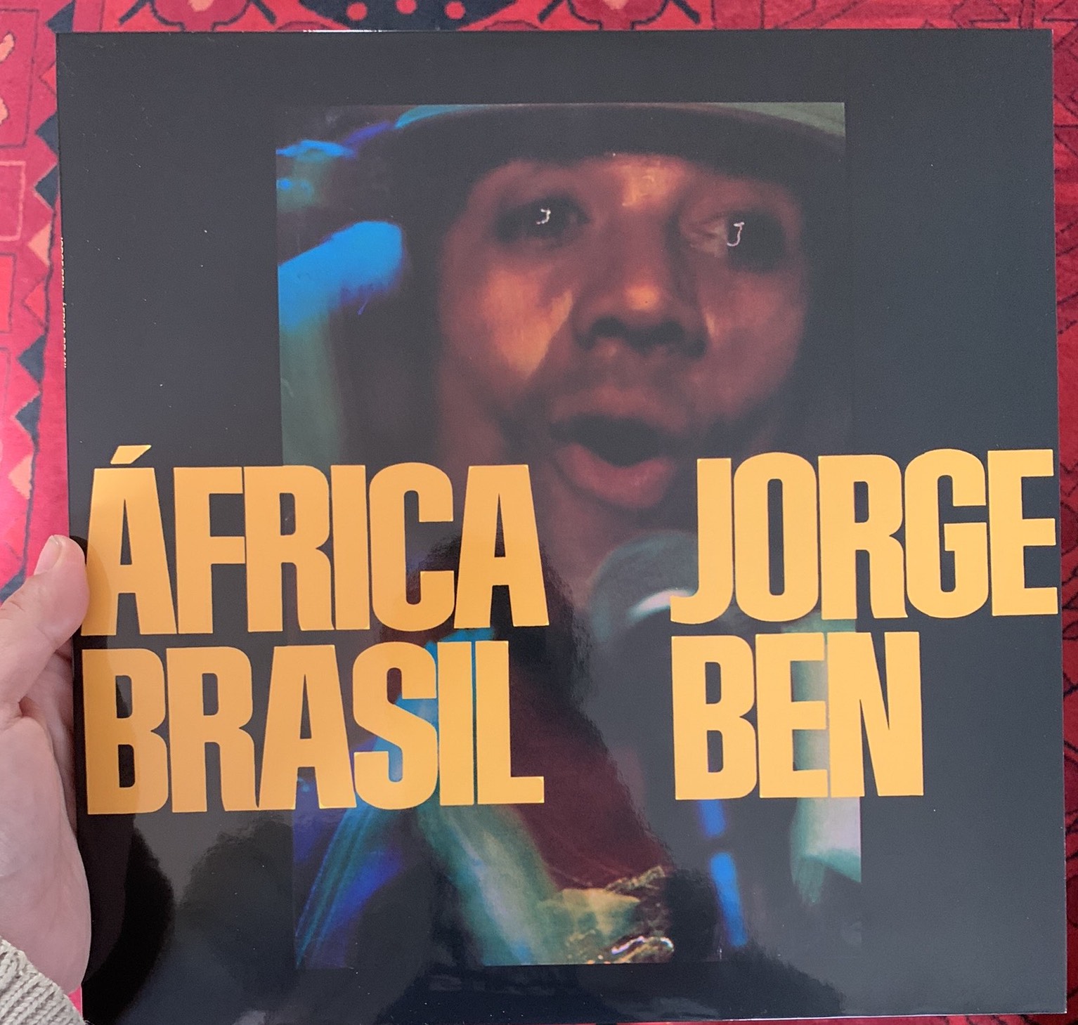 This is an image of Dirt Dog Records founder Zachary Wright holding Jorge Ben's Africa Brasil album. 