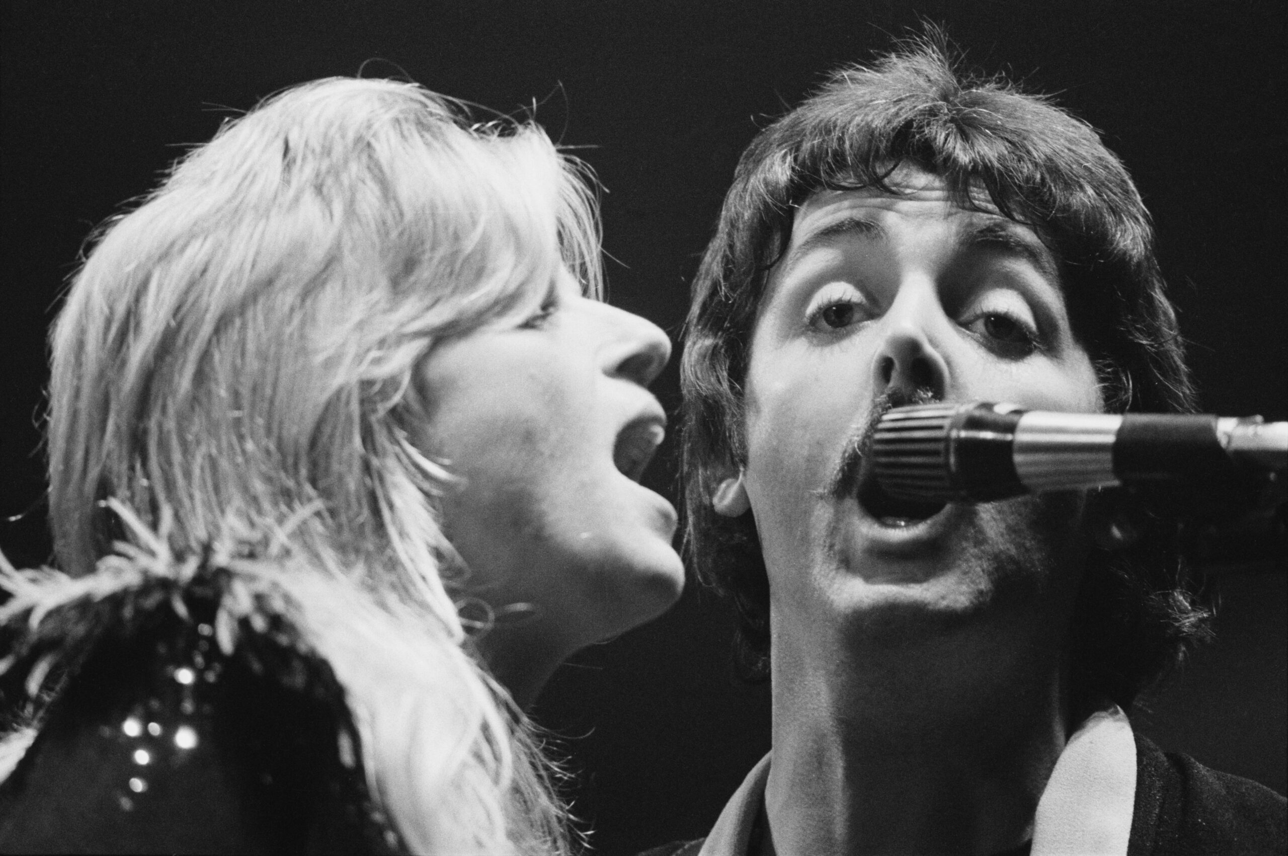 Paul and Linda McCartney performing with Wings in London in 1976 (photo: Wood / Evening Standard / Getty Images / Hulton Archive).
