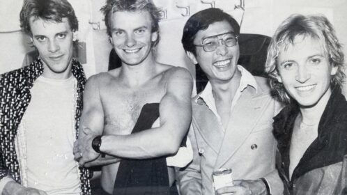 Members of rock band The Police stand with Dr. Ian Chung.