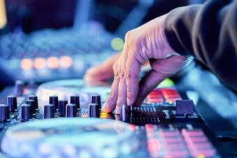 An electrical sound mixer console during concert. (Credit: Aire Images/Getty Images)