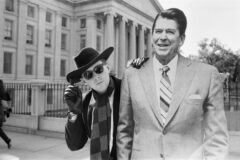 Holly Johnson of Frankie Goes to Hollywood posing outside the White House with a full-size cutout of Ronald Reagan, during their US tour, November 8, 1984 (Credit: Mike Maloney/Mirrorpix/Getty Images)