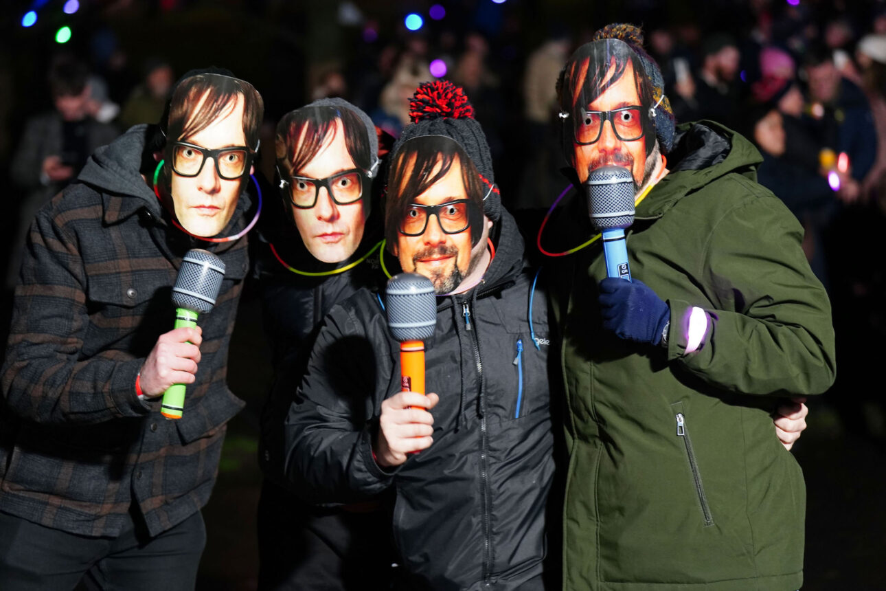 Revellers wear Jarvis Cocker masks ahead of Pulp playing at the New Year Hogmanay Street Party and Concert celebrations in Edinburgh, December 31, 2023. (Credit: Jane Barlow/PA Images via Getty Images)