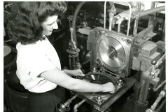 A worker lifts a copy of the Leon Rusk record 'Air Mail Special on the Fly' from a stamper at the King Record Company pressing plant, Cincinnati, Ohio, 1946. (Credit: Marsh Photographic Studio/Cincinnati Museum Center/Getty Images)