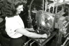 A worker lifts a copy of the Leon Rusk record 'Air Mail Special on the Fly' from a stamper at the King Record Company pressing plant, Cincinnati, Ohio, 1946. (Credit: Marsh Photographic Studio/Cincinnati Museum Center/Getty Images)