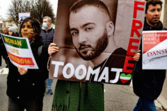 A woman holds up a portrait of rapper Toomaj Salehi during a demonstration against repression in Iran on January 8, 2023 in Lyon, France. (Photo by Robert Deyrail/Gamma-Rapho via Getty Images)