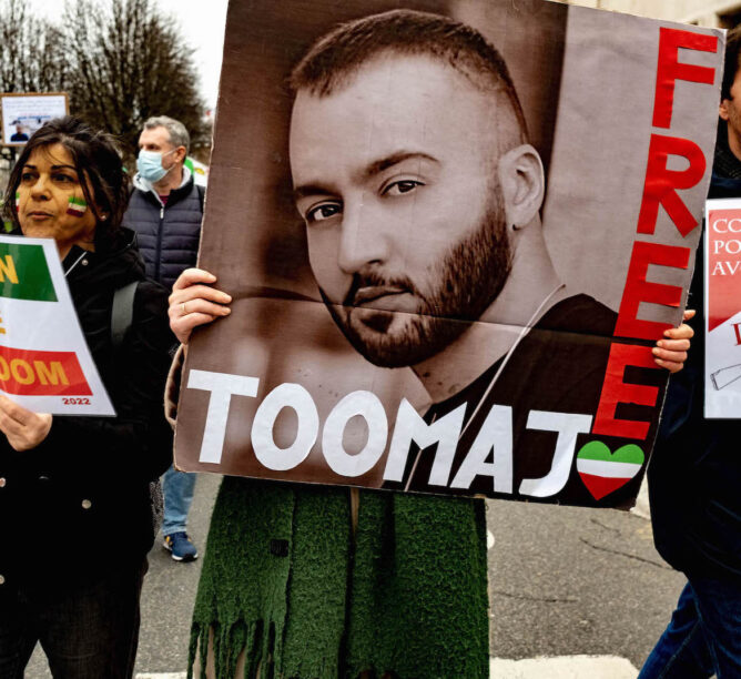 A woman holds up a portrait of rapper Toomaj Salehi during a demonstration against repression in Iran on January 8, 2023 in Lyon, France. (Photo by Robert Deyrail/Gamma-Rapho via Getty Images)