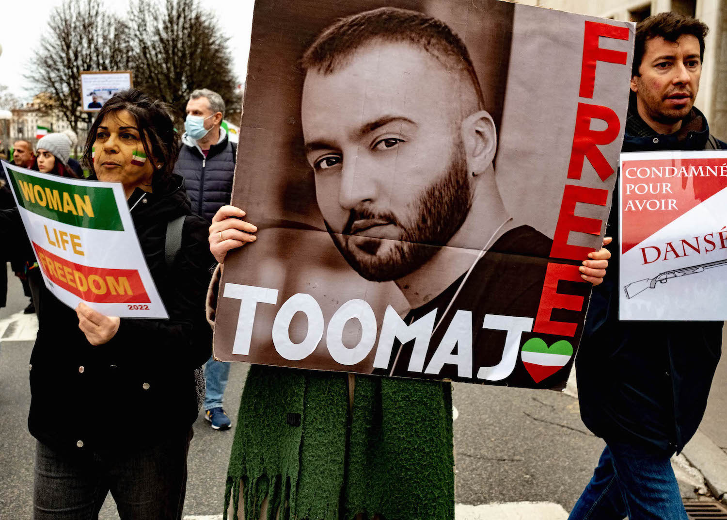 A woman holds up a portrait of rapper Toomaj Salehi during a demonstration against repression in Iran on January 8, 2023 in Lyon, France. (Photo by Robert Deyrail/Gamma-Rapho via Getty Images)