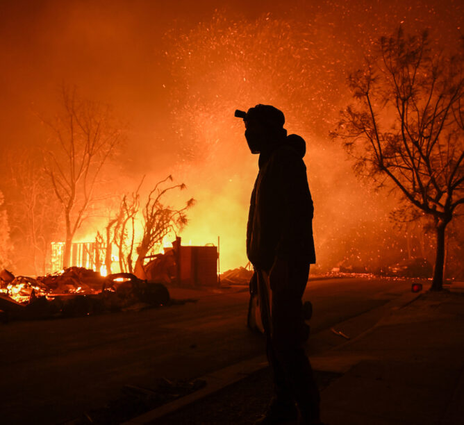 A house is on fire as residents try to escape the site in Pacific Palisades, January 8, 2025. (Credit: Tayfun Coskun/Anadolu via Getty Images)