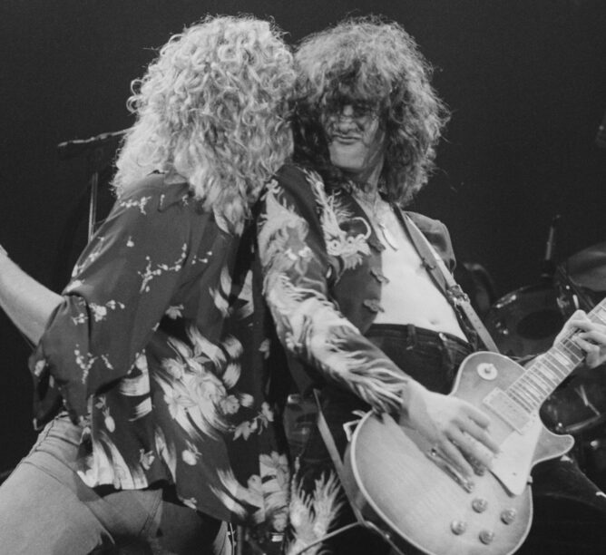 Robert Plant (left) and Jimmy Page performing with Led Zeppelin, at Earl's Court, London, May 1975. The band were initially booked to play three nights at the venue, from 23rd to 25th May, but due to public demand, two more concerts were later added, for 17th and 18th May. Total ticket sales were 85,000. (Credit: Michael Putland/Getty Images)