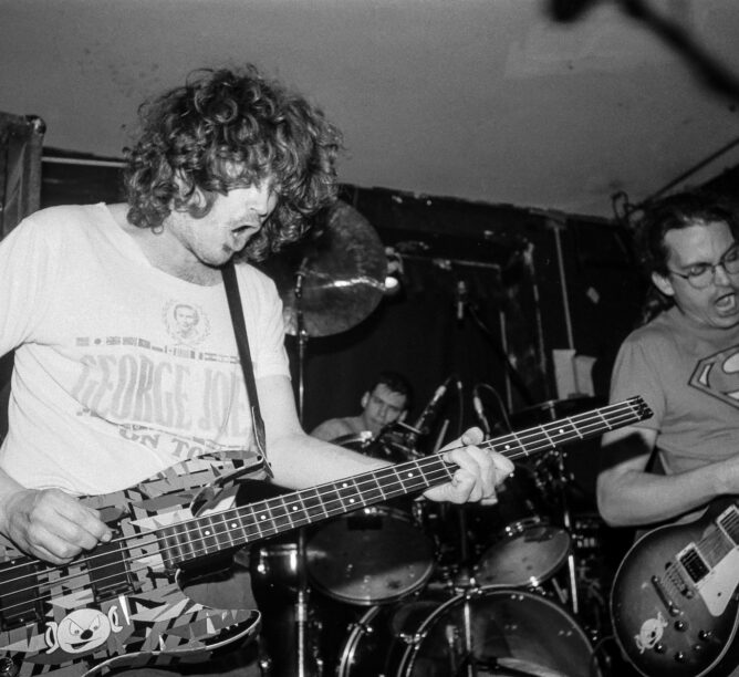 Meat Puppets onstage at the Knitting Factory, New York City, January 24, 1992. From left: Cris Kirkwood, on bass guitar, Derrick Bostrom, on drums, and Curt Kirkwood, on electric guitar. (Credit: Steve Eichner/Getty Images)