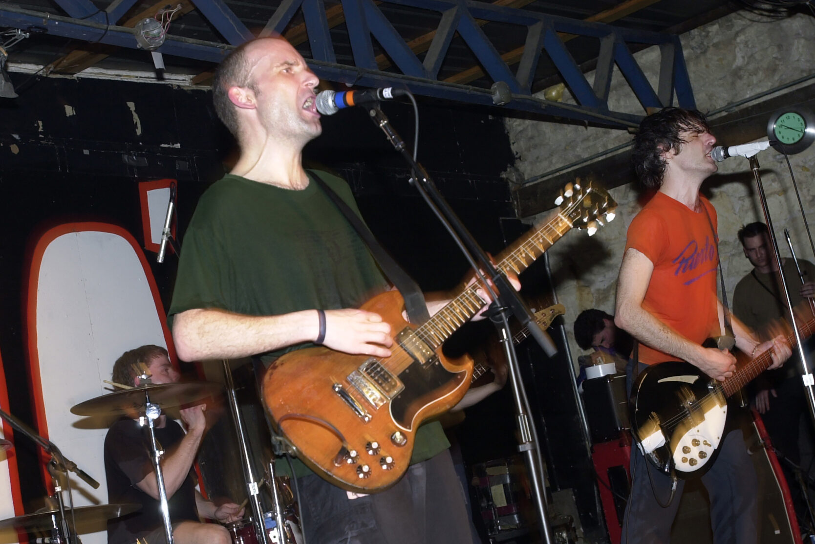 Fugazi performing on stage with intricate lighting