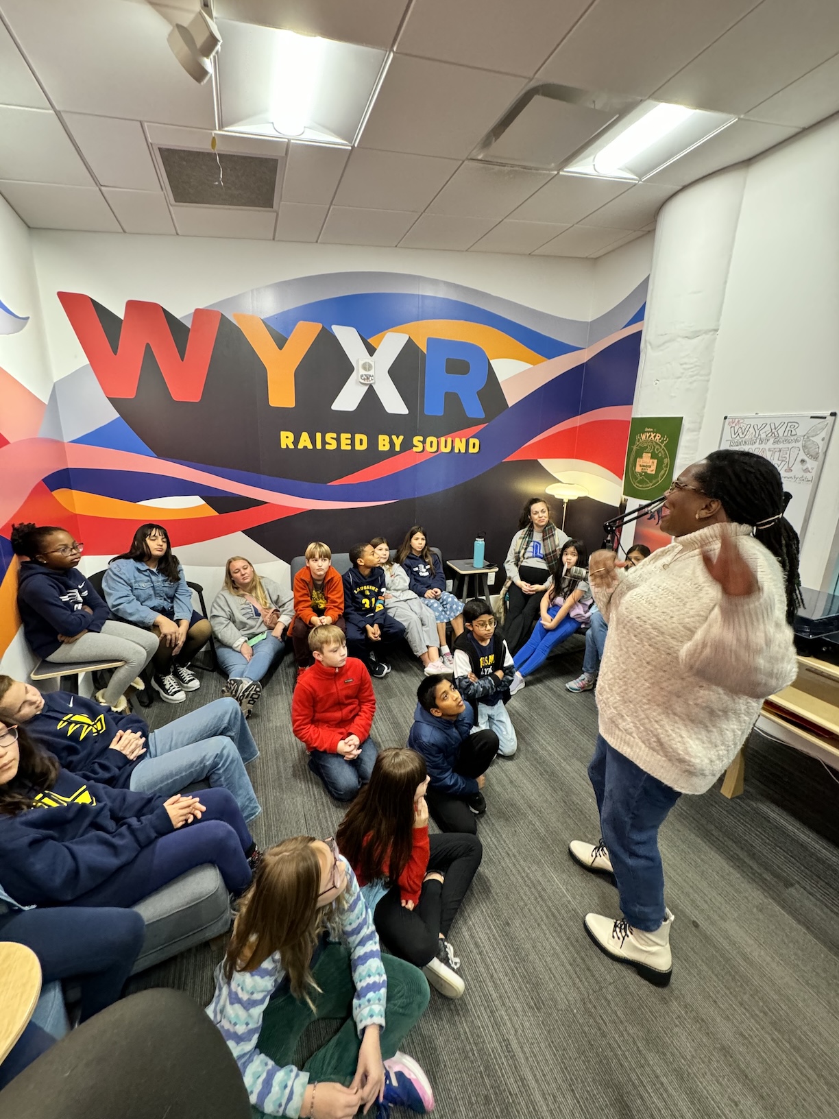 Volunteer DJ Tonya Dyson talking to a group of school kids (Credit: WYXR)