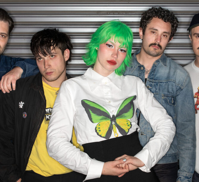 The rock band Scowl, after their performance at the Los Angeles Memorial Coliseum, where they played with headliner Movements, Citizen, and Downward beneath the stadium's Olympic torch. Days earlier, Scowl released a new album, "Are We All Angels." (Left to Right) Guitarists Malachi Greene and Mikey Bifolco, singer Kat Moss, bassist Bailey Lupo, and drummer Cole Gilbert. (Credit: All photos by Steve Appleford)