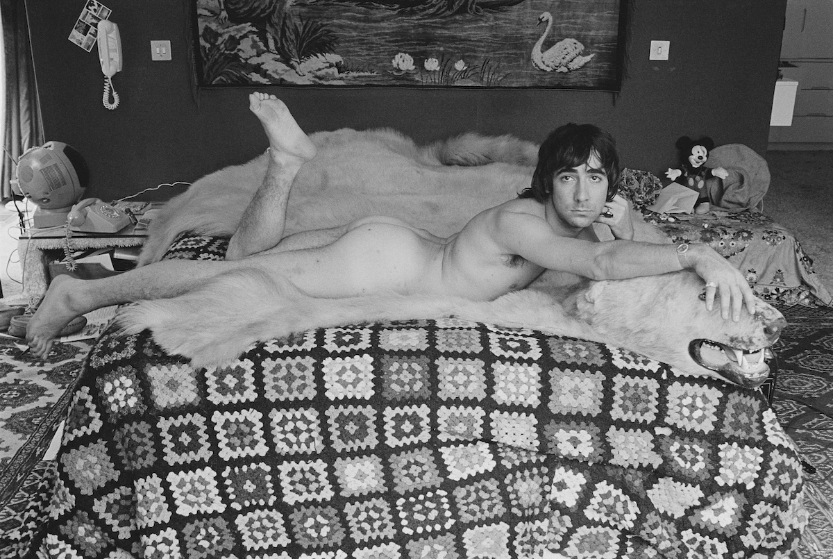 Keith Moon, drummer for the  Who, sprawled across his bed atop a polar bear hide. (Credit: © Shepard Sherbell/CORBIS/Corbis via Getty Images)