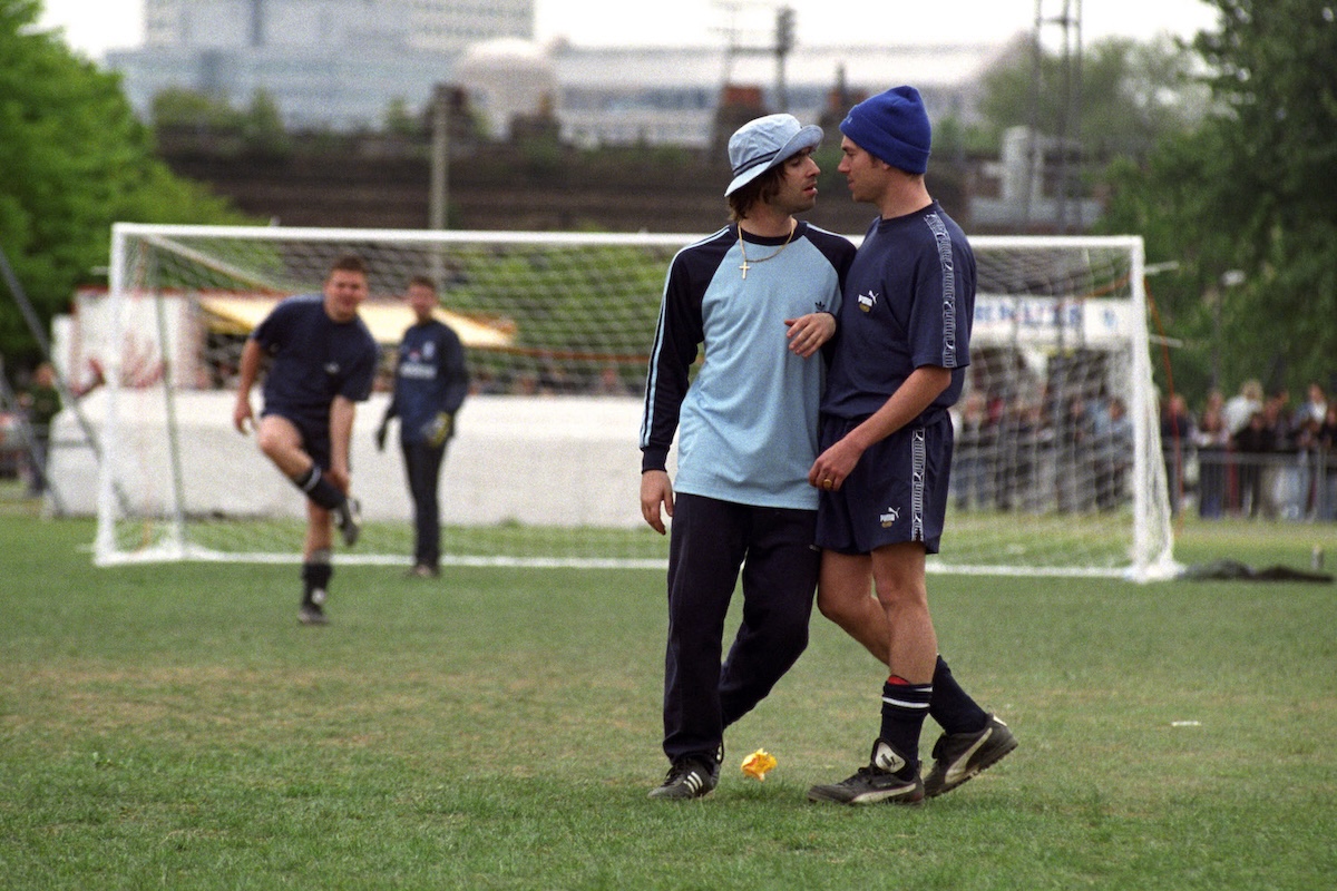 Liam Gallagher of Oasis and Damon Albarn of Blur during the second Music Industry 'Soccer Six' football tournament at Mile End Stadium. (Credit: David Cheskin - PA Images/PA Images via Getty Images)