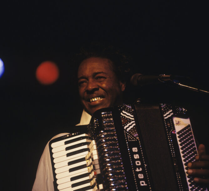 Clifton Chenier performs at the New Orleans Jazz & Heritage Festival on May 4, 1983. (Credit: David Redfern/Redferns)