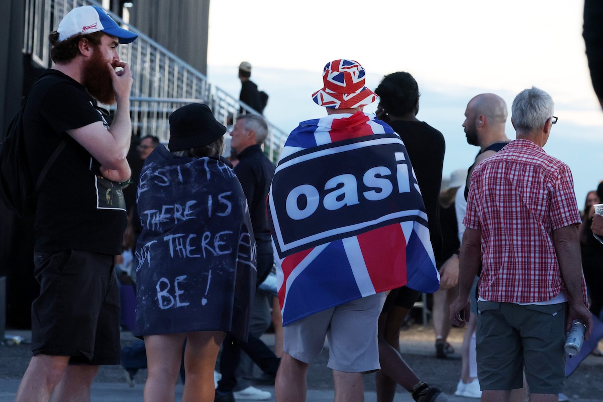 Fans attend the Oasis Live '25 Toronto concert at Rogers Stadium on August 24, 2025. (Credit: Kevin Mazur/Getty Images)