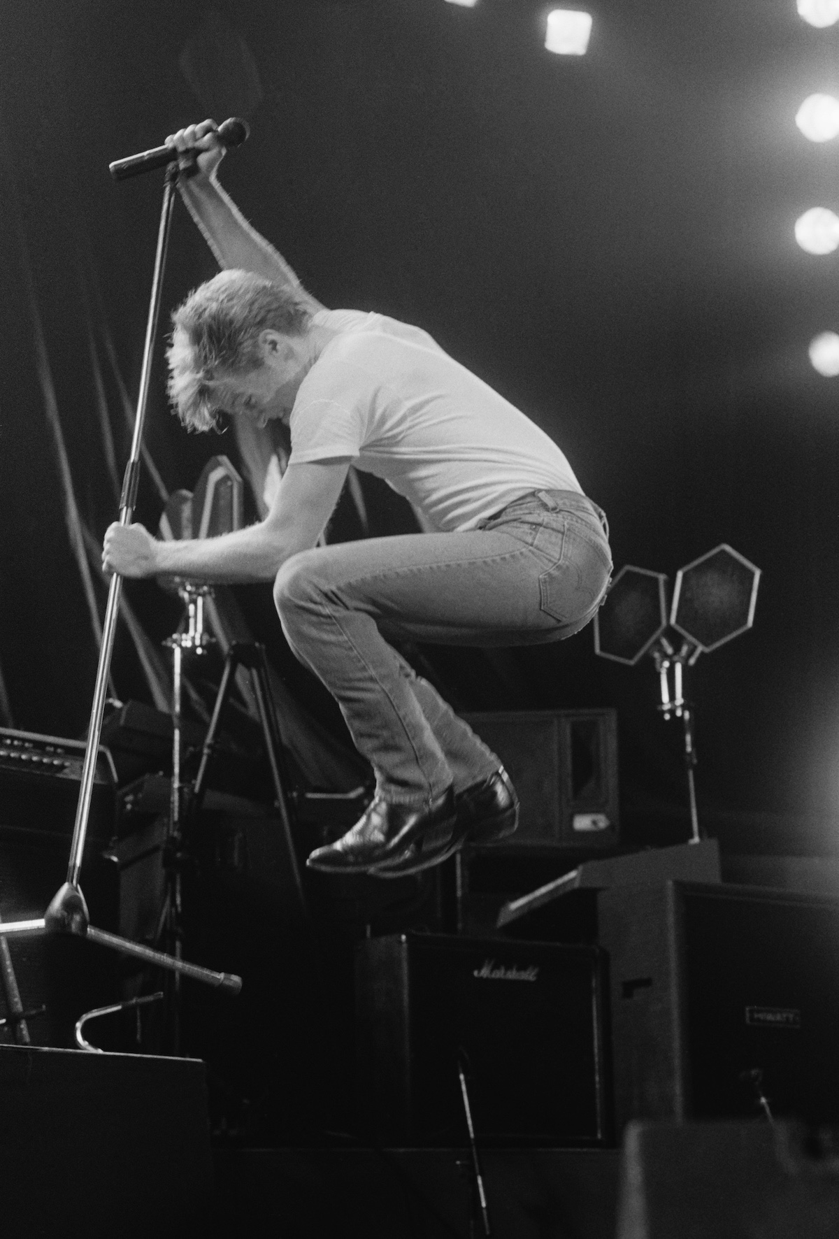 Bryan Adams performing on Tina Turner's Private Dancer Tour, on one of four nights at Wembley Arena, London, 14th-17th March 1985. (Credit: Michael Putland/Getty Images)