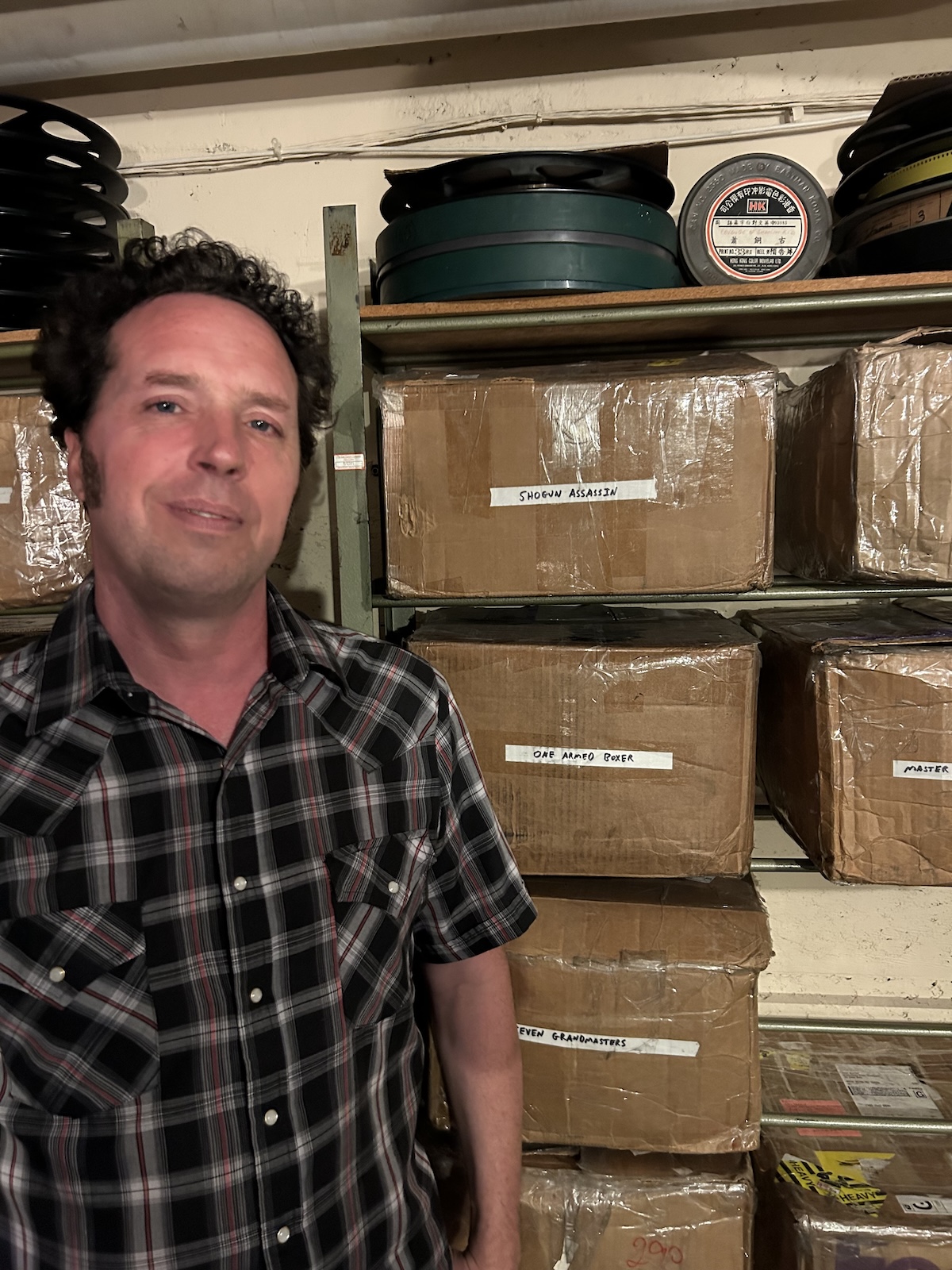 Dan Halsted shows off his collection of 35mm Kung Fu films. (Credit: David Harris)