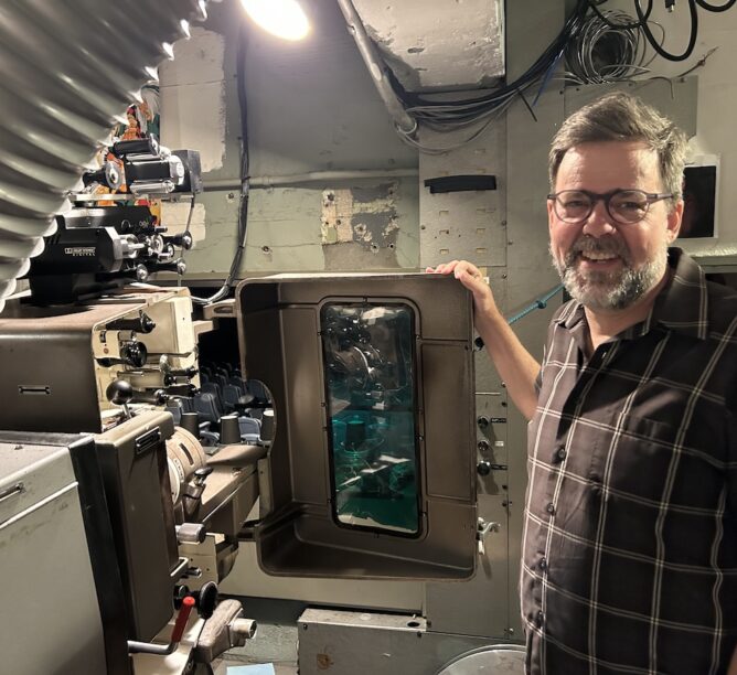 Matt Cunningham, technical director and head projectionist, shows off projector capable of displaying 35mm and 70mm movies. (Credit: David Harris)