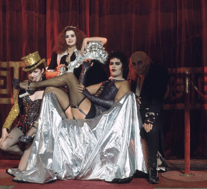 Nell Campbell, Patricia Quinn, Tim Curry, and Richard O'Brien on the set of 'The Rocky Horror Picture Show.' (Credit: Mick Rock)