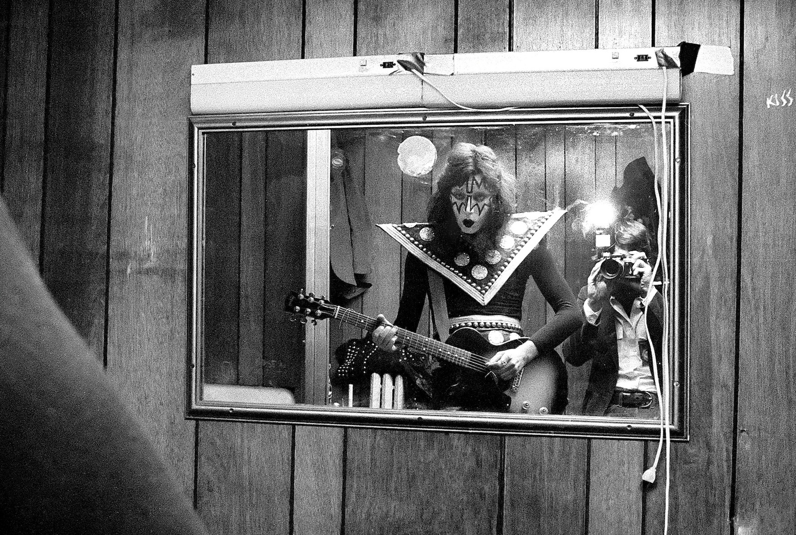 Ace Frehley of Kiss in dressing room at Boston's Orpheum Theater, on May 11, 1975. Photographer Ron Pownall in mirror. (Credit: Ron Pownall/Getty Images)