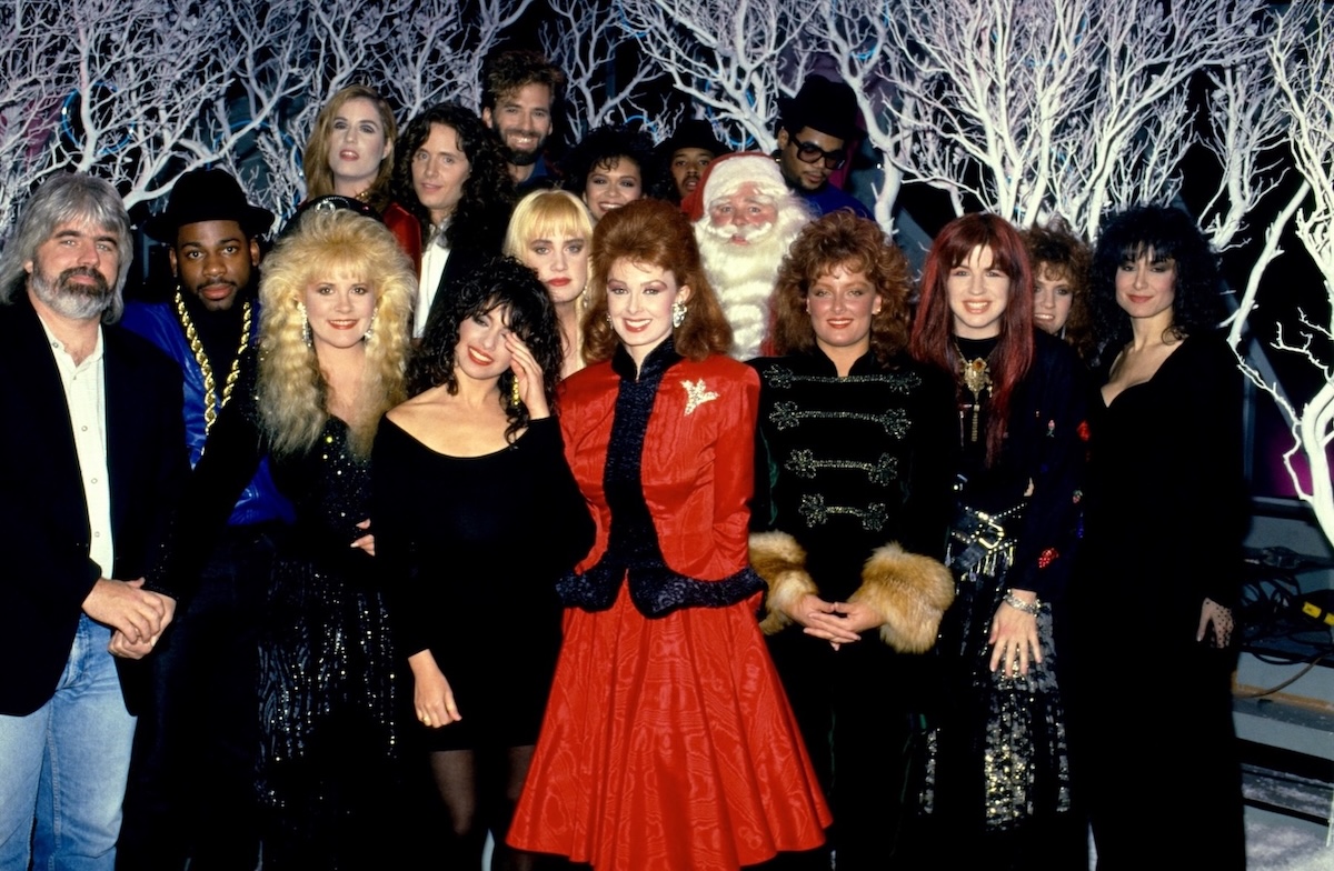(L-R front row) Michael McDonald, Stevie Nicks, Susanna Hoffs, Naomi Judd, Wynona Judd, Michael Steele, (second row), Jason "Jam Master Jay" Mizell, Debbi Peterson, Santa Claus (top row), Vicki Peterson, Robbie Nevil, Kenny Loggins, Nia Peeples, Joseph "Run" Simmons, and Darryl "DMC" McDaniels at the U.S. Top of the Pops show in Los Angeles, California, December 23, 1987. (Credit: Lester Cohen/Getty Images)