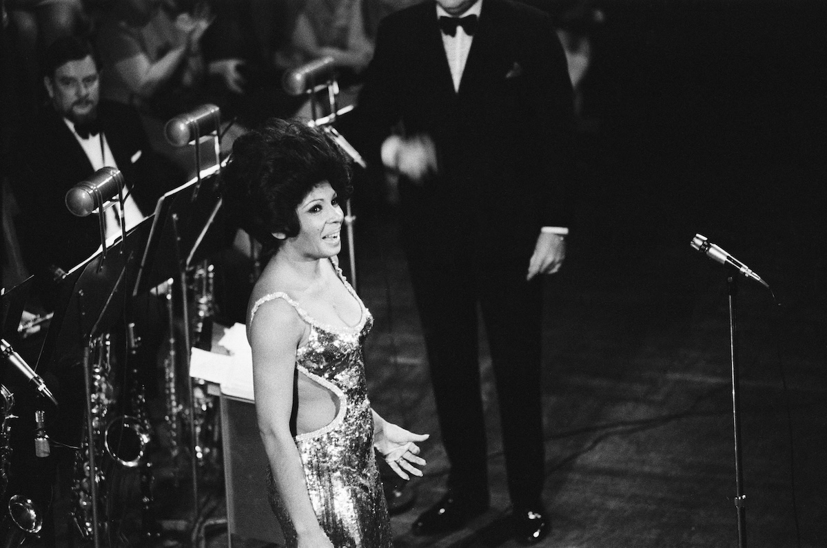 Shirley Bassey, who sang the themes for Goldfinger, Diamonds Are Forever, and Moonraker, performing on stage in concert in 1971. (Credit: Staff/Mirrorpix via Getty Images)