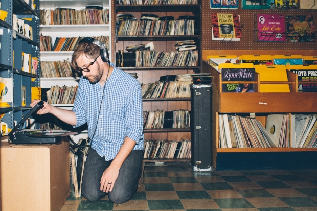 Dustin Drase listens to an album on his portable turntable at the Rock Shop. (Photo by Daymon Gardner)