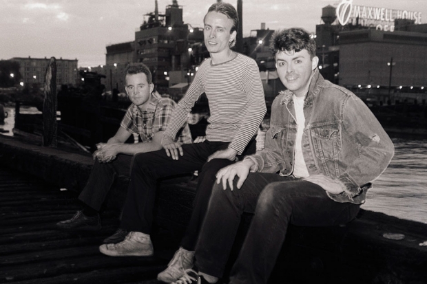 The Bongos pose in front of the Maxwell House Coffee neon sign / Photo by Phil Marino